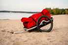 VEOLO Fahrradanhänger mit roter Transporttasche am Strand